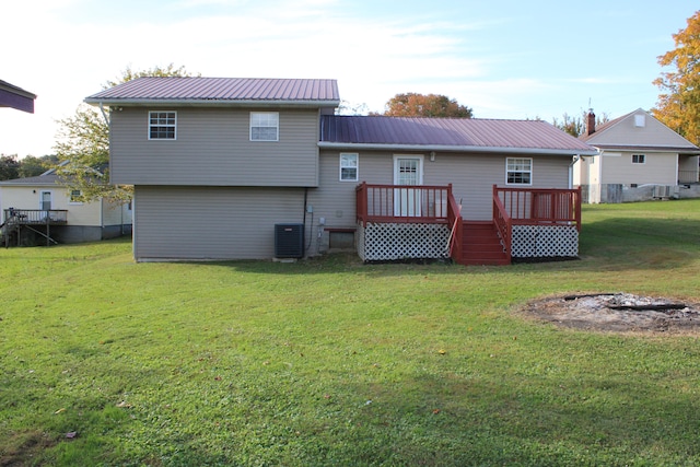 back of property featuring a deck, a yard, and central air condition unit