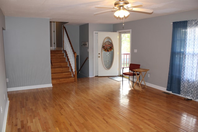 foyer entrance featuring ceiling fan and light wood-type flooring