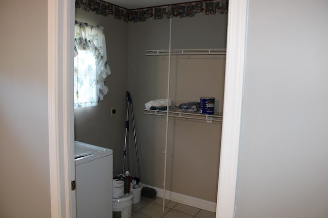 laundry area with light tile patterned floors and washer / dryer