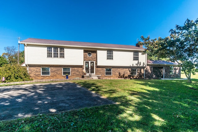 split foyer home with a front lawn