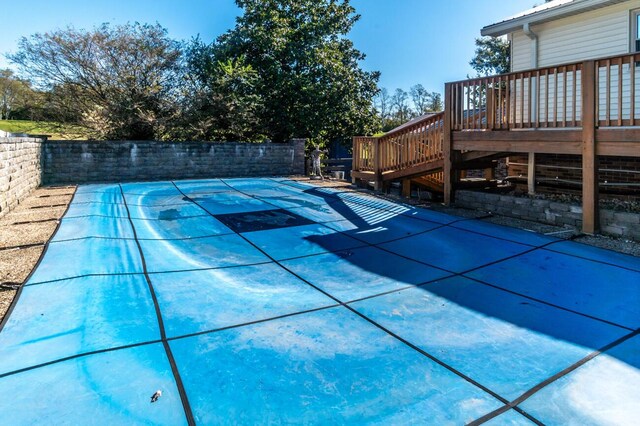 view of pool with a wooden deck