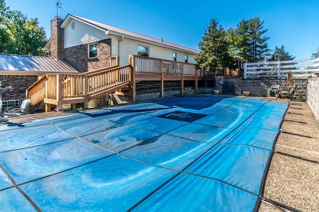 view of swimming pool featuring a wooden deck