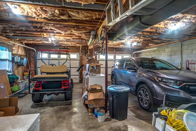 garage with a garage door opener and white refrigerator