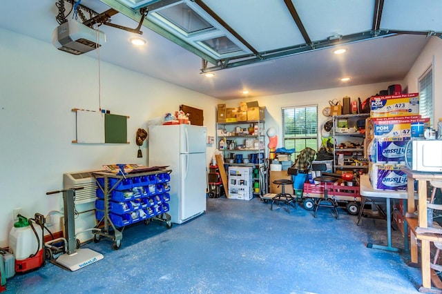 garage with a garage door opener and white refrigerator