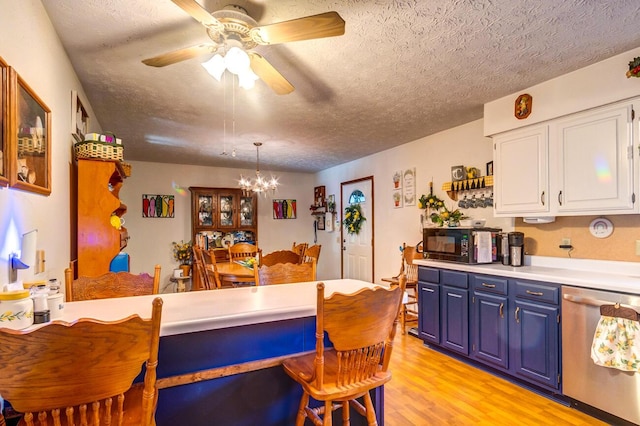 interior space featuring decorative light fixtures, blue cabinets, white cabinetry, dishwasher, and light hardwood / wood-style flooring