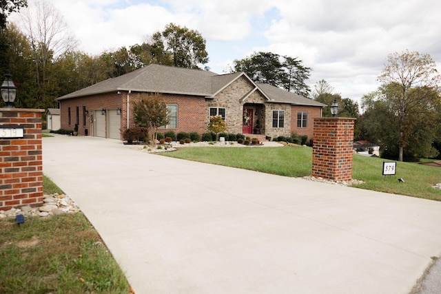 view of front facade with a front yard and a garage