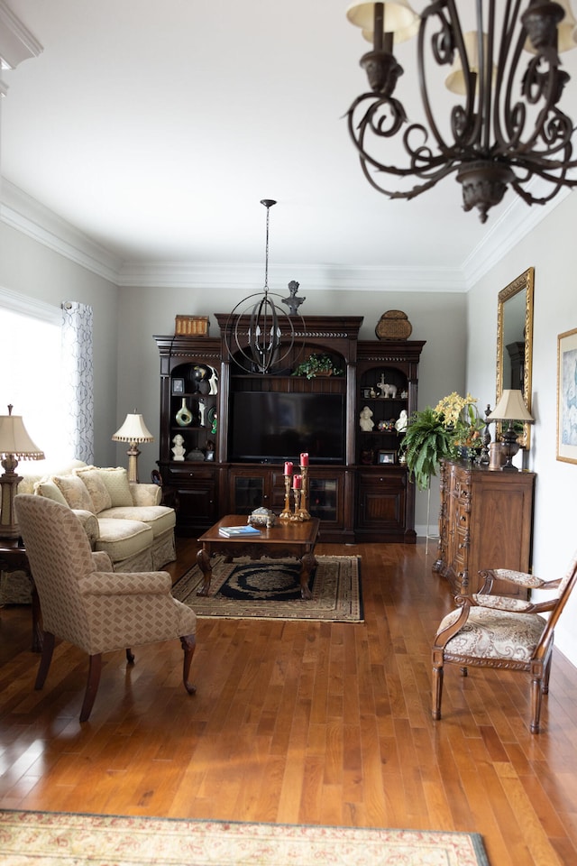 living room with ornamental molding, a notable chandelier, and dark hardwood / wood-style floors