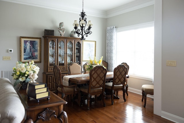 dining space with an inviting chandelier, crown molding, hardwood / wood-style flooring, and a healthy amount of sunlight