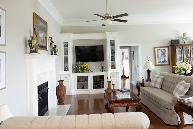 living room with crown molding, wood-type flooring, and ceiling fan