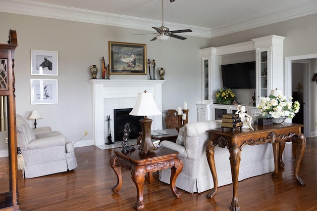 living room featuring ornamental molding, dark wood-type flooring, and ceiling fan