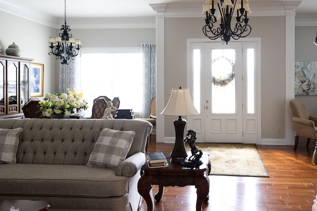 foyer featuring an inviting chandelier, ornamental molding, and wood-type flooring