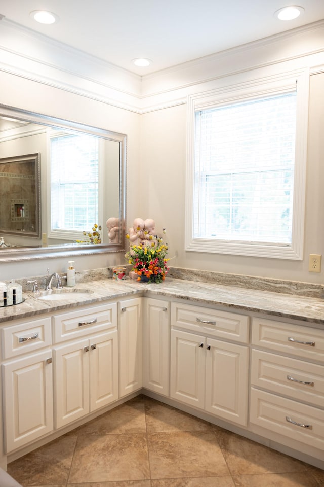 bathroom with vanity, crown molding, and plenty of natural light