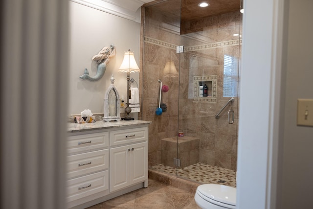 bathroom featuring vanity, tile patterned flooring, toilet, and walk in shower