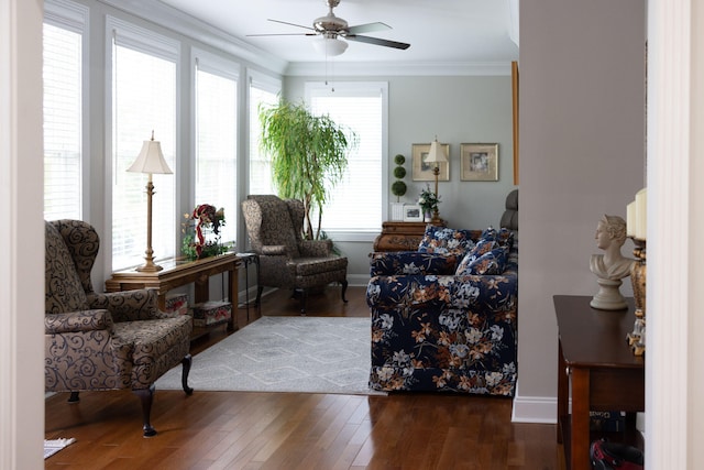 sitting room with ornamental molding, dark hardwood / wood-style floors, and a healthy amount of sunlight