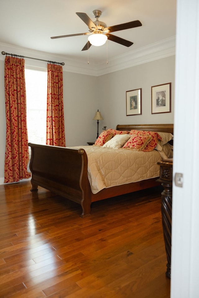 bedroom featuring ornamental molding, hardwood / wood-style floors, and ceiling fan