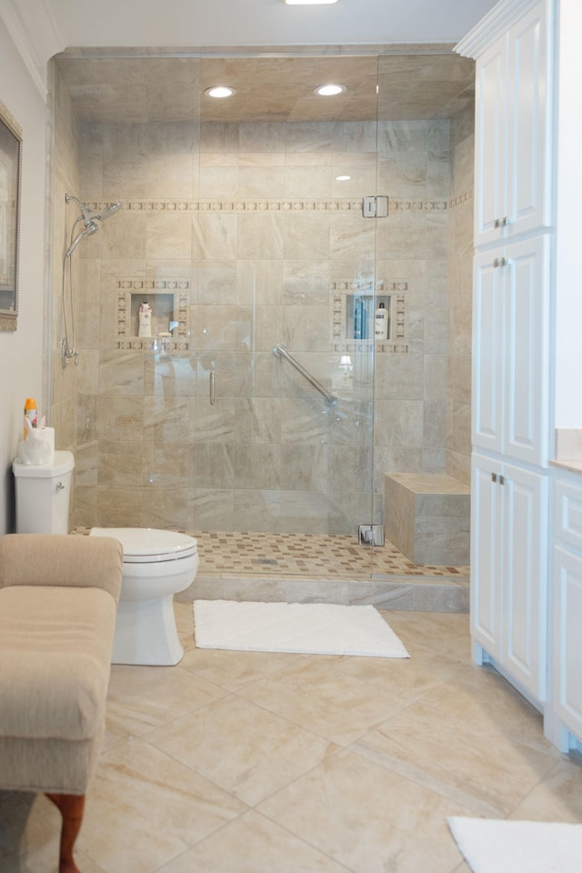 bathroom with tile patterned flooring, toilet, and walk in shower