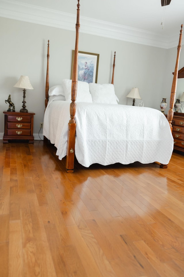 bedroom featuring crown molding and hardwood / wood-style flooring