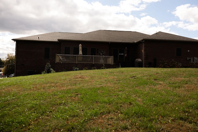 rear view of property with a yard