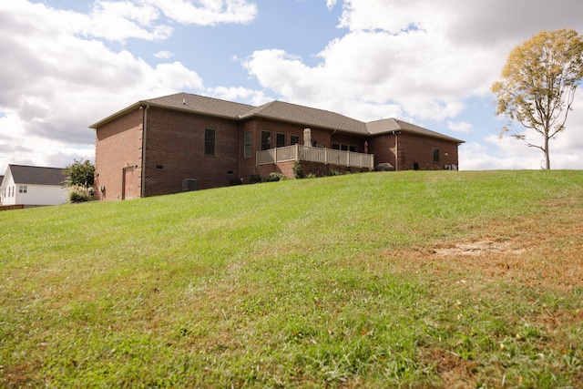 rear view of property featuring a lawn