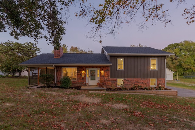 view of front of home with a porch and a yard