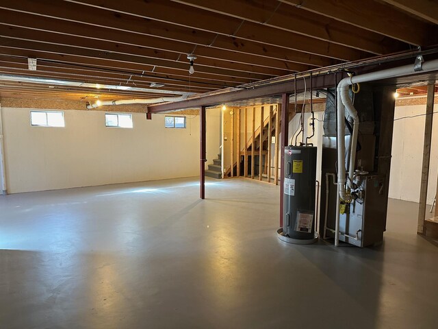 basement featuring heating unit and water heater