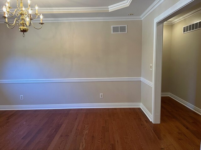 interior space with dark wood-type flooring, crown molding, and an inviting chandelier