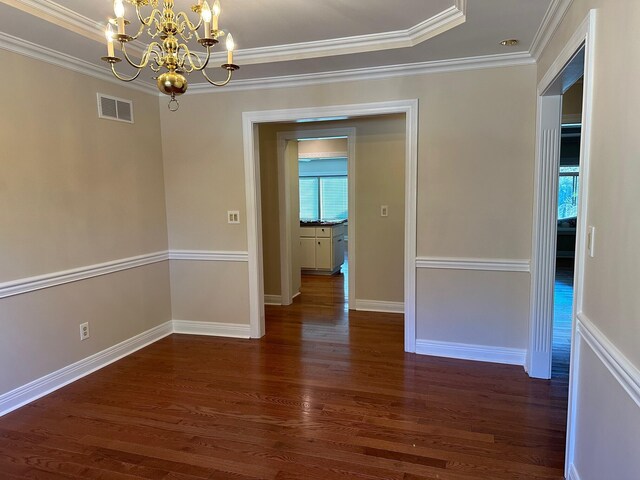 unfurnished room with a notable chandelier, dark hardwood / wood-style floors, and crown molding