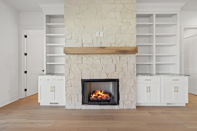 unfurnished living room featuring light hardwood / wood-style flooring and a fireplace