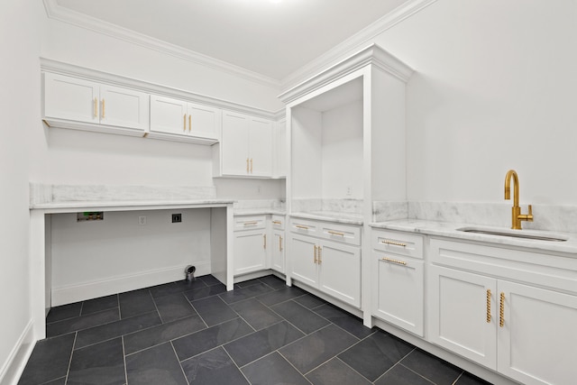 washroom featuring cabinets, ornamental molding, sink, and dark tile patterned flooring