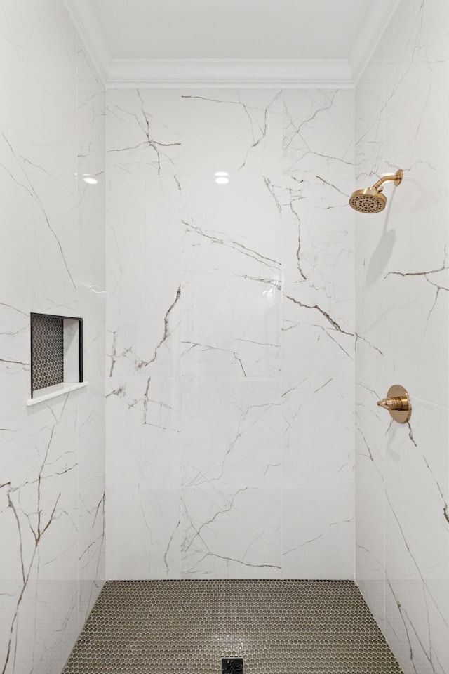 bathroom featuring a tile shower and crown molding