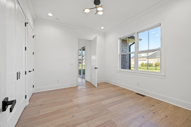 unfurnished room with crown molding and light hardwood / wood-style flooring