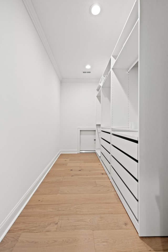 walk in closet featuring light hardwood / wood-style flooring