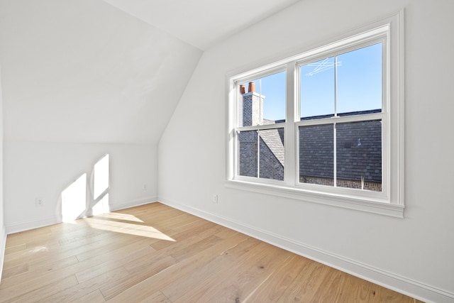 bonus room featuring vaulted ceiling and light hardwood / wood-style flooring