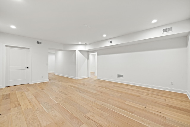 basement with light hardwood / wood-style flooring