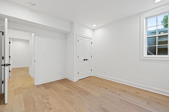 unfurnished room with light wood-type flooring