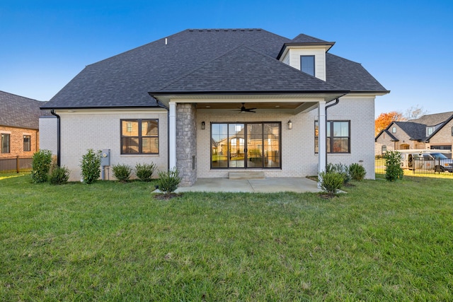 back of house with a yard, a patio, and ceiling fan