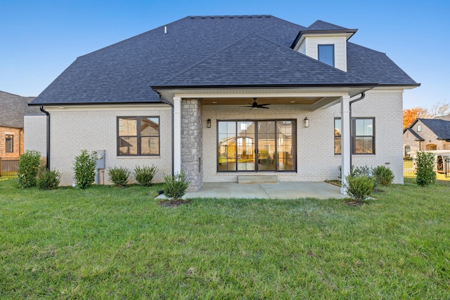 rear view of house featuring a yard, a patio area, and ceiling fan