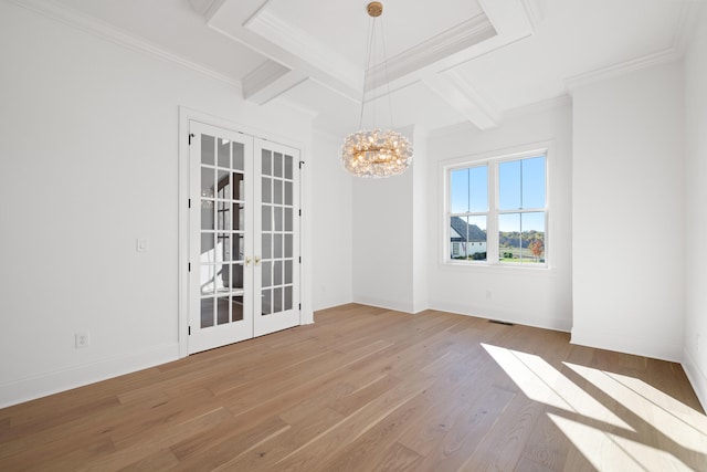 spare room with french doors, light hardwood / wood-style floors, a notable chandelier, and ornamental molding