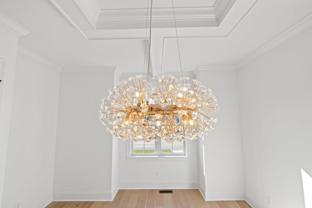 interior details with hardwood / wood-style floors, crown molding, and a chandelier