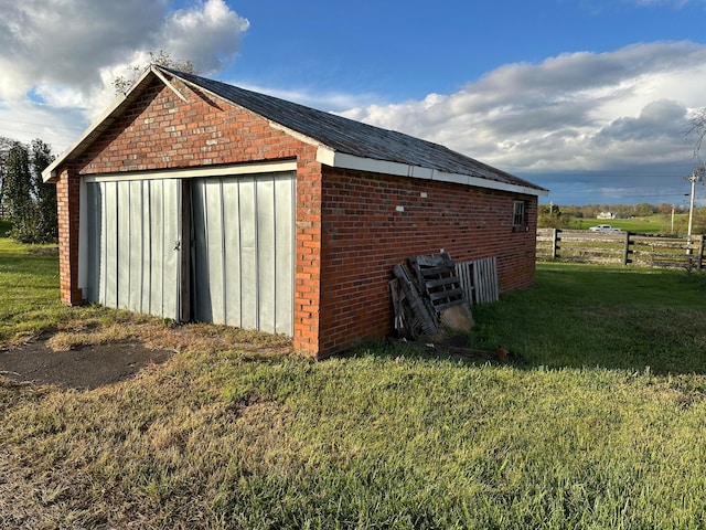 view of outbuilding with a yard