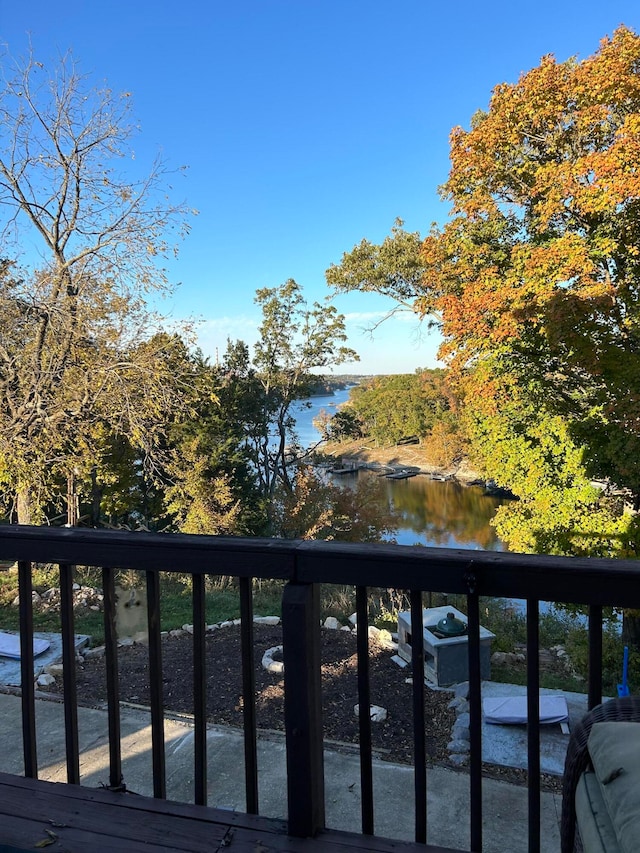 wooden terrace featuring a water view