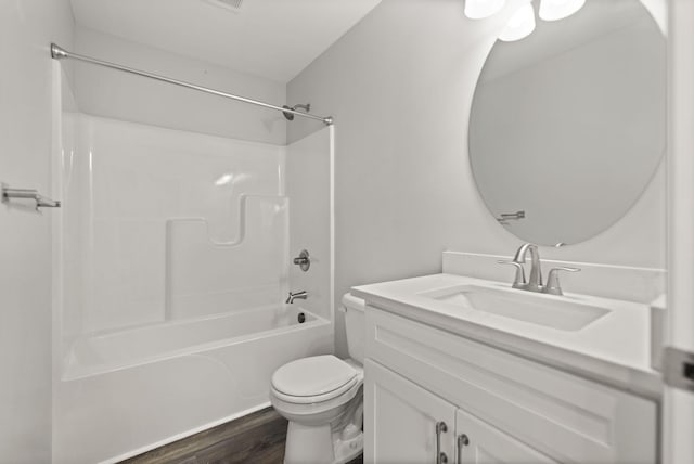 full bathroom with shower / bath combination, wood-type flooring, vanity, and toilet