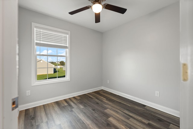 empty room featuring dark hardwood / wood-style flooring and ceiling fan