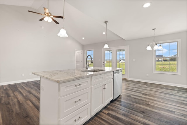 kitchen featuring white cabinets, stainless steel dishwasher, vaulted ceiling, sink, and a kitchen island with sink