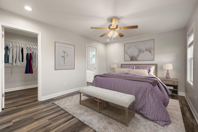 bedroom with dark hardwood / wood-style flooring, multiple windows, and a closet