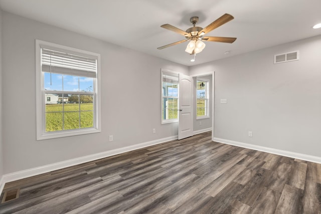 spare room featuring ceiling fan and dark wood-type flooring