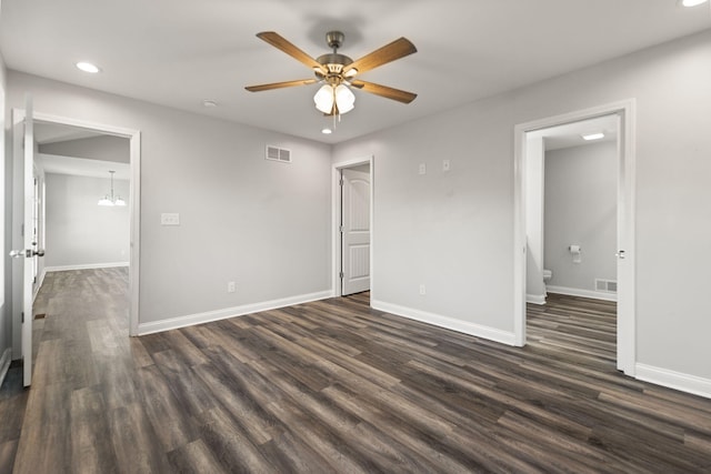 unfurnished bedroom with ceiling fan and dark wood-type flooring