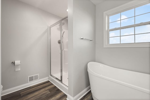 bathroom featuring hardwood / wood-style floors and shower with separate bathtub