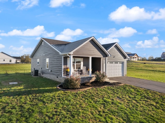 view of front of property featuring a garage, a front yard, cooling unit, and a porch