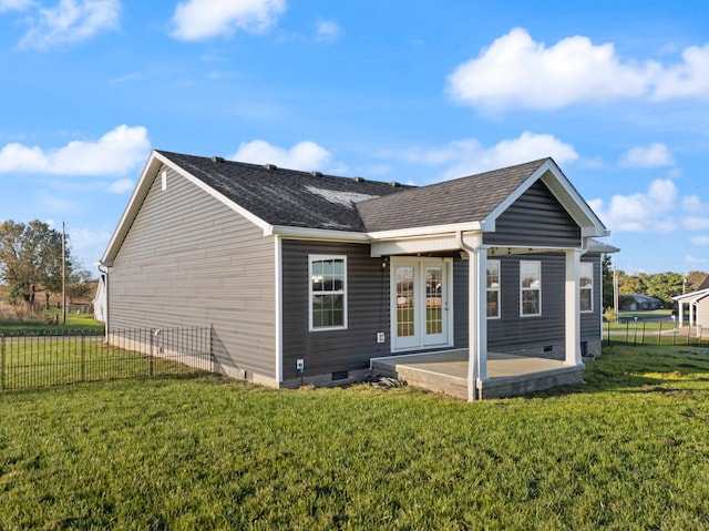 back of property with a lawn and a patio area